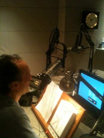 Francis sitting in KQED radio studios during Rick Steves interview